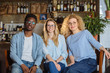 © Iryna - Three multiethnic business coworkers black african american man and two european women friends relaxing bonding in pub after work. Lifestyle,friendship concept with real people models.