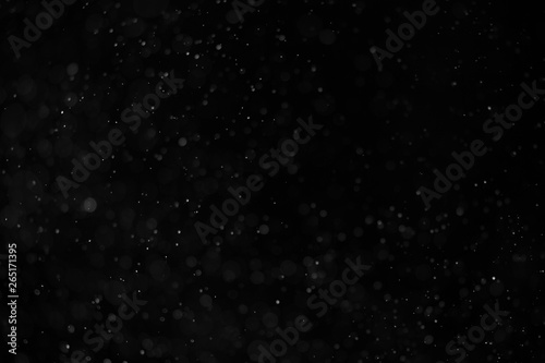 Fotomural Abstract real dust floating over black background