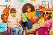 © Sergey Novikov - Little kids learn letters on alphabet in nursery
