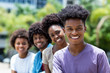 © Daniel Ernst - Laughing african american man with group of young adults in line