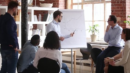 Wall Mural - Confident speaker coach gives corporate presentation on whiteboard at meeting