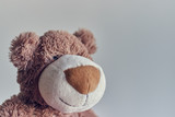Fototapeta  - Teddy bearchildren's toy teddy bear isolated on a light background. closeup of a teddy bear's head.