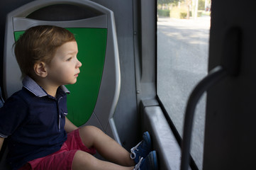 Little boy going by bus