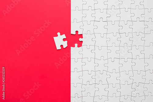 Fotografía Red background made from white jigsaw puzzle pieces and place for your content