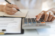 © Pormezz - close up view hand of person calculating income balance.