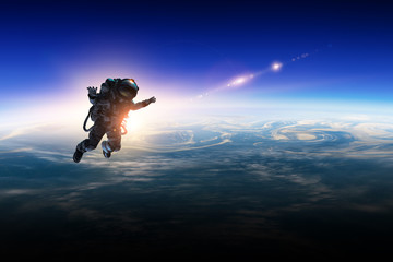 Wall Mural - astronaut in space on planet orbit.