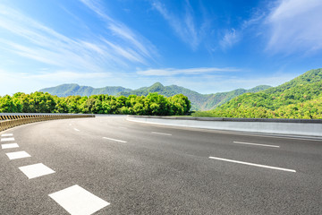 Country road and green mountains natural landscape under the blue sky