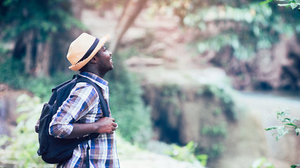 Wall Mural - African man traveler smile and relax in jungle.Survival travel concept.