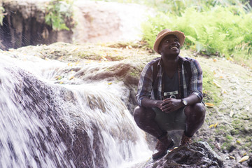 Wall Mural - African man traveler smile and relax in jungle.Survival travel concept.