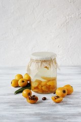 Poster - compote or syrup from a loquat in a glass jar. Preparation of a syrup from a loquat with sugar. canning fruit.