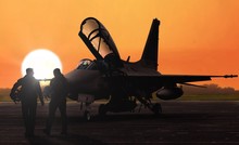 Jet Fighter Pilots Silhoutte At Dusk Sunset On Military Base Airfield