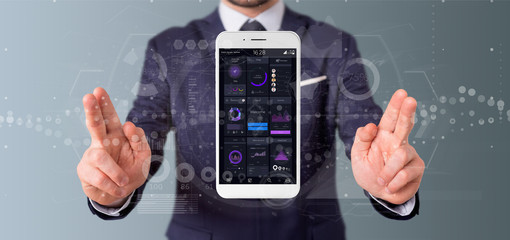 Poster - Businessman holding Smartphone with user interface data on the screen isolated on a background