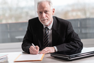 Businessman signing a document (Lorem ipsum text used)