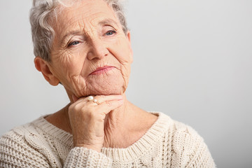 Portrait of senior woman on white background