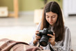 © Pixel-Shot - Young girl with modern photo camera at home