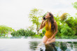 © siraphol - Portrait beautiful young asian woman with cell phone or mobile phone around swimming pool at hotel resort
