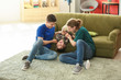 © Pixel-Shot - Happy gay couple with adopted child at home