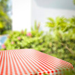 © magdal3na - Tablecloth of red and white color and summer background of garden. Free space for your decoration.