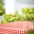 © magdal3na - Tablecloth of red and white color and summer background of garden. Free space for your decoration.