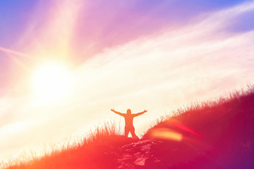 Poster - Copy space of man raise hand up on top of mountain and sunset sky abstract background.