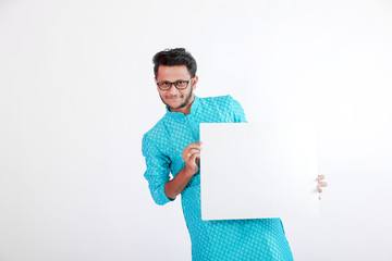 happy Young indian man showing blank poster