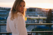 Beautiful blond girl posing at sunset in bathrobe