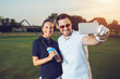 © zorandim75 - Young couple making selfie on a golf course