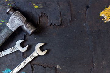 closeup set of tools for motorbike repair on dark background. top view