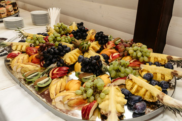 Wall Mural - rich many fresh fruits on luxury wedding table at the reception, catering in restaurant