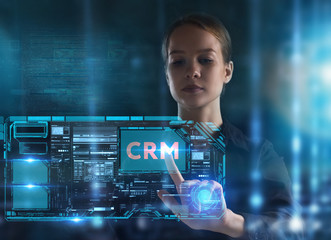 The concept of business, technology, the Internet and the network. A young entrepreneur working on a virtual screen of the future and sees the inscription: CRM