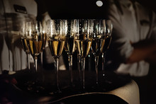 Stylish Glasses With Champagne At Evening Light At Wedding Ceremony, Catering And Service At Restaurant