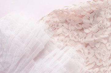 soft pink tulle and lace fabrics texture on pink background.