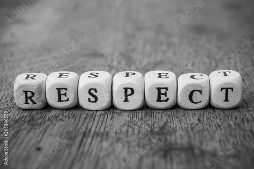 Cuadros en Lienzo Closeup of word on wooden cube on wooden desk background concept - Respect