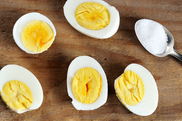 Wall Mural - halves of boiled egg and salt in a teaspoon