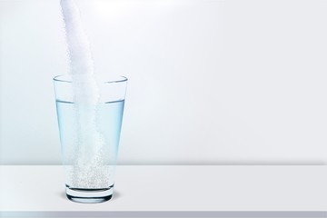 Pouring powder on water glass on  background