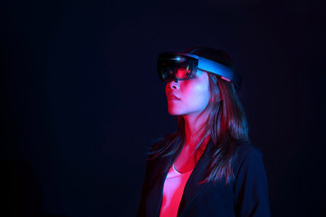 Business woman try vr glasses hololens in the dark room | Portrait of young asian girl experience ar | Future technology concept