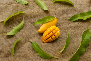 Sticker - Mango fruit sliced decorated with leaf and put on vintage cloth background