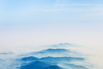 Aerial landscape mountains lost in thick fog in China, bird eye view landscape look like a chinese style of painting