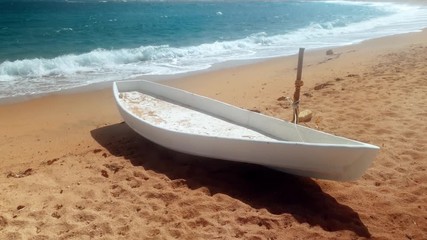 Wall Mural - 4k video of old wooden fisherman boat lying on sandy beach at windy day