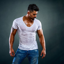 Handsome Male Fitness Model Wearing Jeans And White T-Shirts