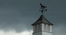 Close Up Time Lapse Weathervane On A Windy Day With Dark Clouds Blowing