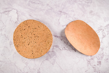 Two cork plates on a gray marble background