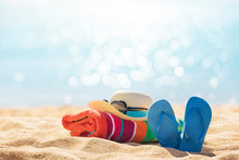 Beach Accessories Straw Hat, Flip Flops, Towel On Sunny Tropical Beach, Summer Holidays