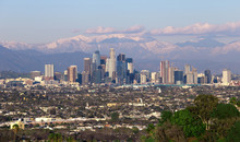 Panoramic View Of The City Of Los Angeles California With Snowy Mountain Caps Showing The End Of The Drought Due To Climate Change.  The Wide View Shows Hollywood And Downtown.