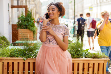 Canvas Print - Young African American black woman in pink dress talking on cellphone