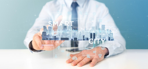Poster - Businessman holding Smart city user interface with icon, stats and data 3d rendering