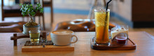 Hot Coffee Drink And Cold Iced Lemon Tea Put On Wooden Table In Cafe