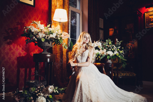 Beautiful And Sensuality Blondie Bride Sitting On Chair In Luxury