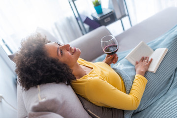 Wall Mural - Relaxed young woman reading a book