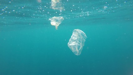 Poster - Plastic bags in ocean. Plastic pollution of environment in sea with fish 